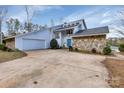 Beautiful home displaying stone accents, manicured landscaping, and attached two-car garage at 192 Diana Dr, Mount Gilead, NC 27306
