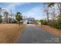 Attractive house with a long driveway, stone accents and palm trees at 192 Diana Dr, Mount Gilead, NC 27306