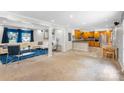Open-concept living room with plush white sofa, blue accents, and a view into the kitchen and dining area at 213 Lakeview Dr, Harrisburg, NC 28075