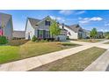 Lovely home with a well-manicured lawn, beautiful landscaping, and a two-car garage at 213 Warbler Dr, Monroe, NC 28110