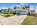 Attractive house boasting a two-car garage, tasteful landscaping, and an American flag at 213 Warbler Dr, Monroe, NC 28110