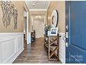 Inviting entryway features wood-look flooring, stylish decor, and a convenient display table at 213 Warbler Dr, Wesley Chapel, NC 28110