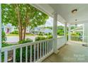 The view from the front porch showcases well-maintained homes in the neighborhood and large tree at 2305 Blueberry St, Belmont, NC 28012