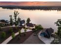 Aerial view showcases a waterfront property surrounded by lush greenery and tranquil lake waters at 249 Landing Trl, Mount Gilead, NC 27306