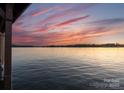Scenic lake view capturing the sunset over calm waters, offering a serene atmosphere at 249 Landing Trl, Mount Gilead, NC 27306