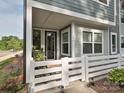 Inviting front porch featuring a stylish door with glass and white picket fence, perfect for enjoying quiet moments at 306 Cloudcroft Aly, Charlotte, NC 28217