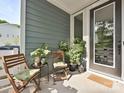 Charming covered front porch with seating and plants, creating a cozy entrance to the home at 306 Cloudcroft Aly, Charlotte, NC 28217