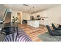 Open-concept living space with a spacious kitchen island, modern appliances, and stylish flooring for seamless entertaining at 306 Cloudcroft Aly, Charlotte, NC 28217
