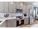 Close-up of the kitchen featuring stainless steel appliances, modern cabinets, and white subway tile backsplash at 316 S Turner Ave # 11, Charlotte, NC 28208
