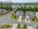 An aerial view showcases the neighborhood, mature trees and a beautifully landscaped yard at 3205 Berry Creek Rd, Charlotte, NC 28214