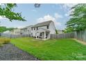 The backyard is completely fenced in, with a small covered seating area off the back of the house at 3205 Berry Creek Rd, Charlotte, NC 28214