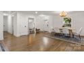 Bright dining room with hardwood floors, a large mirror, and a view of the entry at 3538 Denson Pl, Charlotte, NC 28215