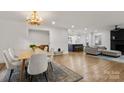 Open concept with new hardwood floors, a dining room and fireplace at 3538 Denson Pl, Charlotte, NC 28215