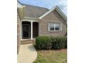 A welcoming front entrance framed by white columns and complemented by manicured shrubbery at 4048 Avis Way, Monroe, NC 28110