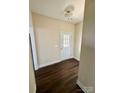 Bright hallway featuring wood-look flooring and a glass-paneled door at 4048 Avis Way, Monroe, NC 28110