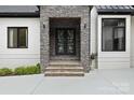 Stone clad entrance with modern double doors at 4135 Mineral Ln, Lincolnton, NC 28092