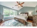 Bright main bedroom with large windows, hardwood floors, and a ceiling fan at 4201 Beauvista Dr, Charlotte, NC 28269