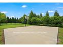 Spacious 1200 sq ft backyard with a basketball court and surrounded by lush greenery at 422 Deer Brush Ln, Waxhaw, NC 28173