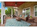 Inviting covered porch with comfortable furniture and views of the private backyard at 422 Deer Brush Ln, Waxhaw, NC 28173