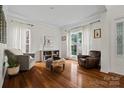 Bright living room with hardwood floors, and two armchairs next to large windows at 422 Deer Brush Ln, Waxhaw, NC 28173