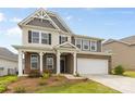 Attractive two-story home featuring a well-manicured lawn, brick accents, and a two car garage at 423 Shallowford Dr, Rock Hill, SC 29732