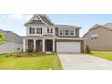 Classic two-story home with brick and siding, attached two car garage, and inviting curb appeal at 423 Shallowford Dr, Rock Hill, SC 29732