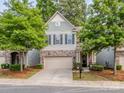 Charming two-story home with a well-maintained lawn, attached garage, and traditional architectural details at 5130 Mount Clare Ln, Charlotte, NC 28210