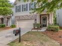 Attractive home exterior features a stone facade, manicured landscaping, and a welcoming front porch at 5130 Mount Clare Ln, Charlotte, NC 28210