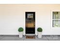 Inviting front entrance features black door, potted plants, and a 'Welcome' doormat at 514 Rich St, Rock Hill, SC 29730