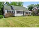 Classic home with green shutters, stone accents, and a lush green lawn at 514 W Sumter St, Shelby, NC 28150