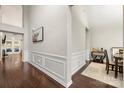 Well-lit foyer featuring dark hardwood floors and white molding, connecting to dining and living areas at 5818 Downfield Wood Dr, Charlotte, NC 28269