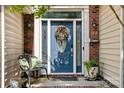 Inviting front door with decorative wreath, sidelights, and bench with pillows at 5818 Downfield Wood Dr, Charlotte, NC 28269
