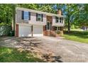 Charming split-level home boasts a two-car garage and traditional design at 6839 Wagon Oak Rd, Charlotte, NC 28212