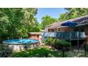 Backyard features a deck, above ground pool, mature trees and a privacy fence for outdoor enjoyment at 701 5Th Ne Ave, Conover, NC 28613