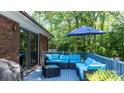 Relax on the deck with comfortable seating and a serene view of the wooded surroundings at 701 5Th Ne Ave, Conover, NC 28613