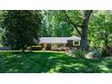 Well-maintained home with a lush lawn and mature landscaping and colorful flowers at 701 5Th Ne Ave, Conover, NC 28613