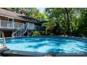Backyard pool surrounded by a deck, greenery, and a well-maintained lawn provides an inviting outdoor space at 701 5Th Ne Ave, Conover, NC 28613