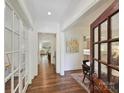 Inviting foyer showcasing hardwood floors, natural light, and entry to living spaces at 7011 Conservatory Ln, Charlotte, NC 28210