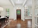 Spacious foyer with hardwood floors, a dark door, and view to the interior at 7011 Conservatory Ln, Charlotte, NC 28210