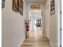 Bright hallway features light wood floors, neutral paint and offers a view into the living area at 8008 Brookbank Dr, Charlotte, NC 28269