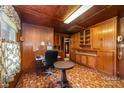 Cozy wood-paneled office space with built-in cabinets, desk area, and unique flooring at 908 Taylor St, Kannapolis, NC 28083