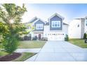Beautiful home with manicured lawn, showcasing a two-car garage and tasteful landscaping at 9586 Kartey Nw Ave, Concord, NC 28027