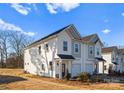 An exterior view of modern duplexes featuring a white and grey color scheme, and landscaping at 9713 Misenheimer Rd # 4A, Charlotte, NC 28215