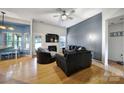 Bright living room with hardwood floors, a fireplace, and stylish furniture, perfect for relaxation at 1021 Stinson Glen Ln, Charlotte, NC 28214