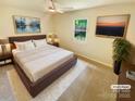 Cozy bedroom with a ceiling fan, a window, and neutral tones, virtually staged with modern decor at 10701 Copper Field Dr, Pineville, NC 28134