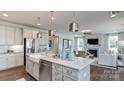 Contemporary kitchen with stainless steel appliances, marble countertops, and an adjacent living space at 11913 Casabella Dr, Huntersville, NC 28078
