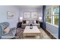 Cozy living room with large window, comfortable seating, stylish decor, and natural light at 1390 6Th Ne St, Hickory, NC 28601