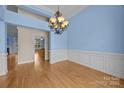 The dining room features a chandelier, hardwood floors, and detailed wall trim at 1607 Essex Hall Dr, Rock Hill, SC 29730