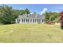 Attractive one-story brick home featuring dormer windows and a spacious front lawn at 208 Armstrong Dr, Belmont, NC 28012