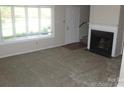 Inviting living room with plush carpeting, a fireplace, and bright natural light at 214 Idlewood Dr, Kannapolis, NC 28083